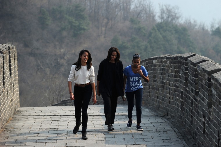 Michelle Obama walks with her daughters Malia and Sasha