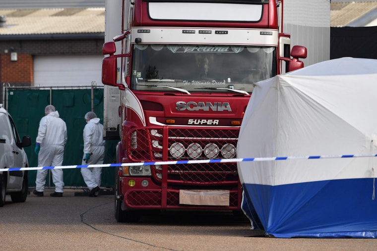 Image: Police officers in a forsensic suits at the scene of a lorry found to be containing 39 dead bodies at Waterglade Industrial Park in Grays, Essex, on Oct. 23, 2019.