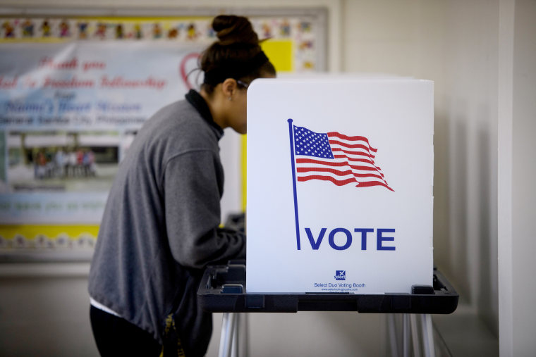 Image: A voter casts a ballot during midterm elections in Cambridge, Ohio