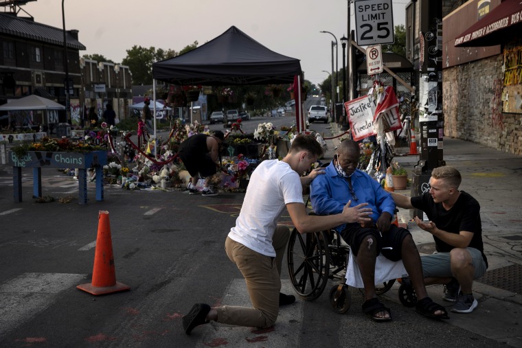 A local Christian group prays at the site of his memorial in Minneapolis on Aug. 25, 2020.