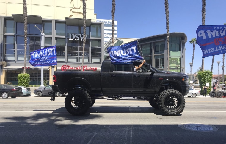 A truck joins a pro-President Donald Trump caravan driving past Black Lives Matter protesters gathered outside Sherman Oaks Galleria in Los Angeles on Sunday.
