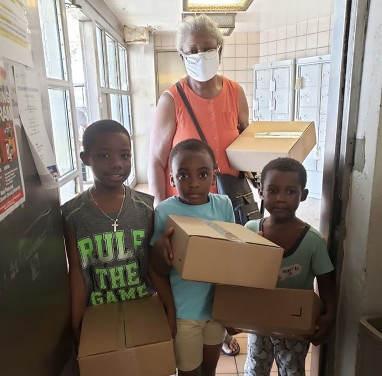 A family from the Bronx collects their meals from a designated pickup location.