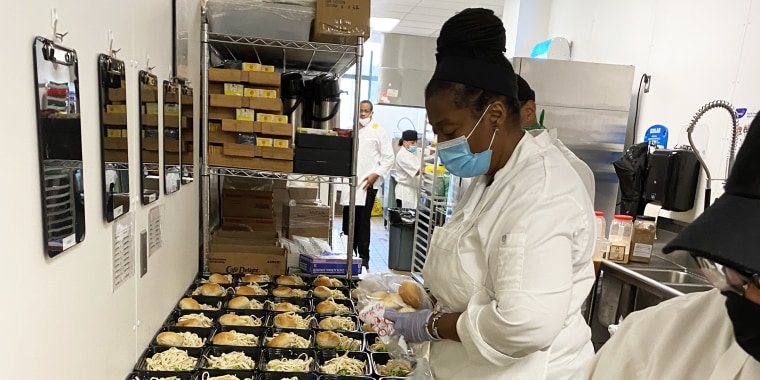 Chef Millie Peartree packs to-go containers with balanced meals for families in need to pick up.