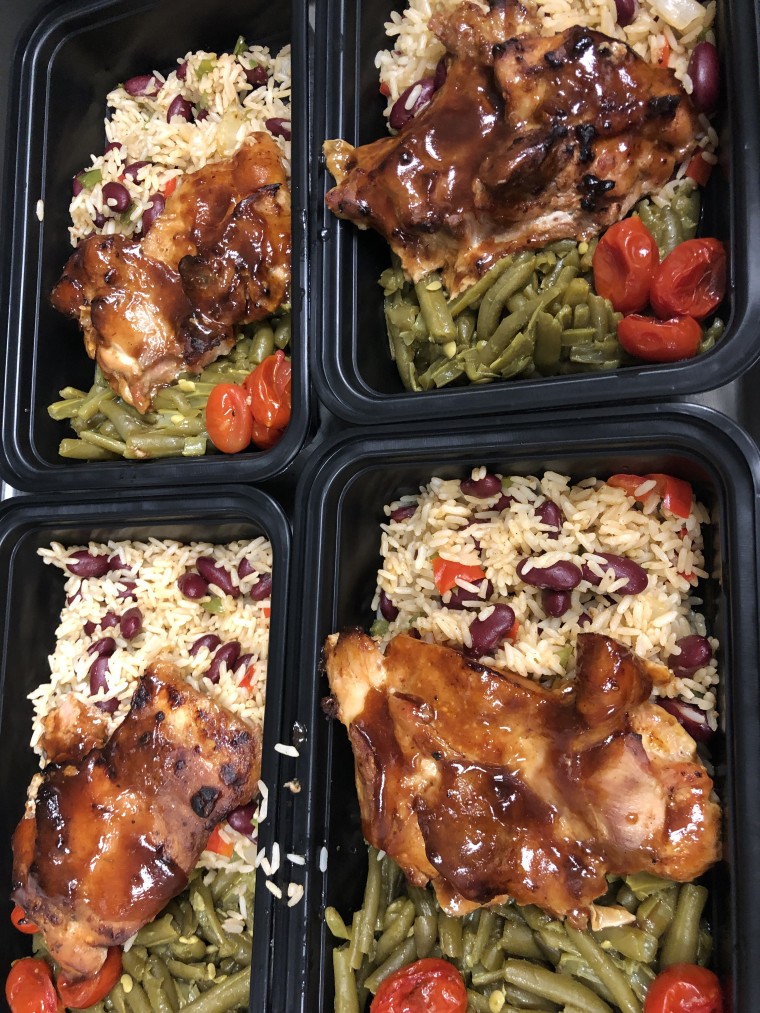 A typical Full Heart Full Bellies meal: barbecue chicken, Creole rice and beans and smothered green beans.