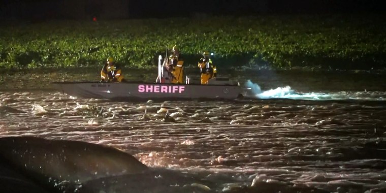 Two children are missing after the car they were in was swept away in floodwaters early Tuesday morning.