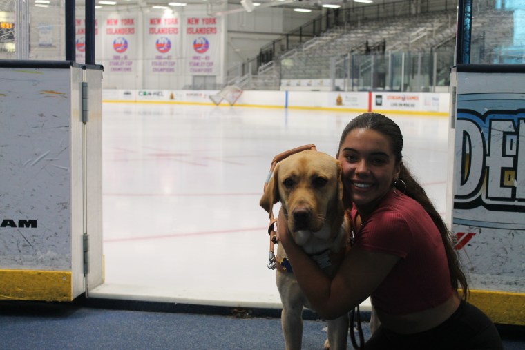 Anastasia Pagonis and Radar at a hockey rink.