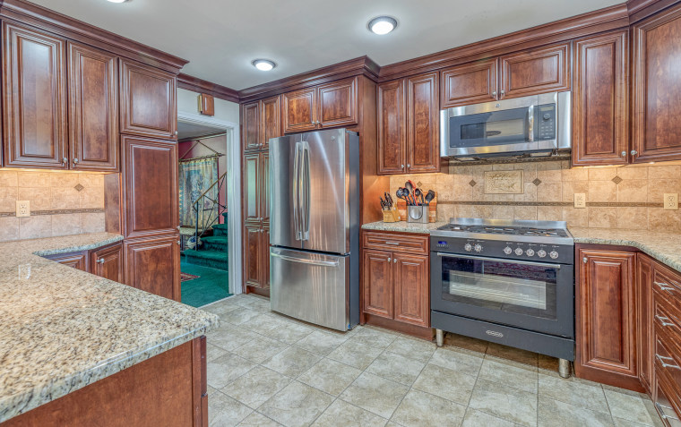 The kitchen has plenty of countertop space for preparing and cooking family meals.