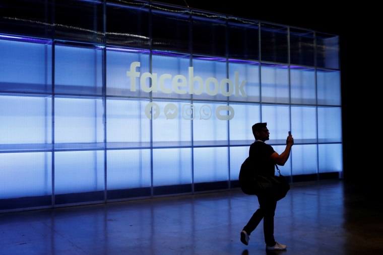Image: An attendee takes a photograph of a sign during Facebook Inc's F8 developers conference in San Jose, California