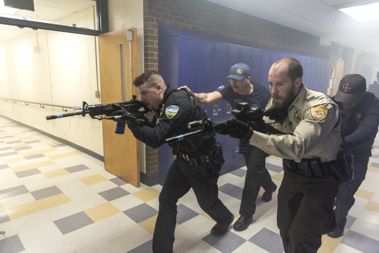 Image: Livingston Police Department officers, Park County Sheriff's officers, and Livingston Fire Department EMS employees conduct an active shooter drill at Park High School in Livingston, Montana, on April 27, 2018.