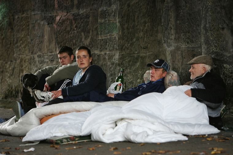 IMage: Homeless people sit under a bridge where they live on the banks of the River Clyde in Glasgow, Scotland.
