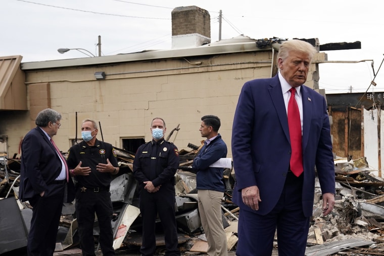 Image: President Donald Trump turns around after talking with law enforcement officials Tuesday, Sept. 1, 2020, as he tours an area damaged during demonstrations after a police officer shot Jacob Blake in Kenosha