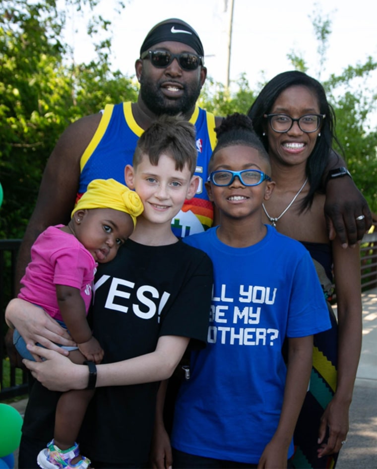 Andrew Gill holds his baby sister, Kynnedi, while posing for a family photo with his brother, Joc, and parents Dominique and Kevin.
