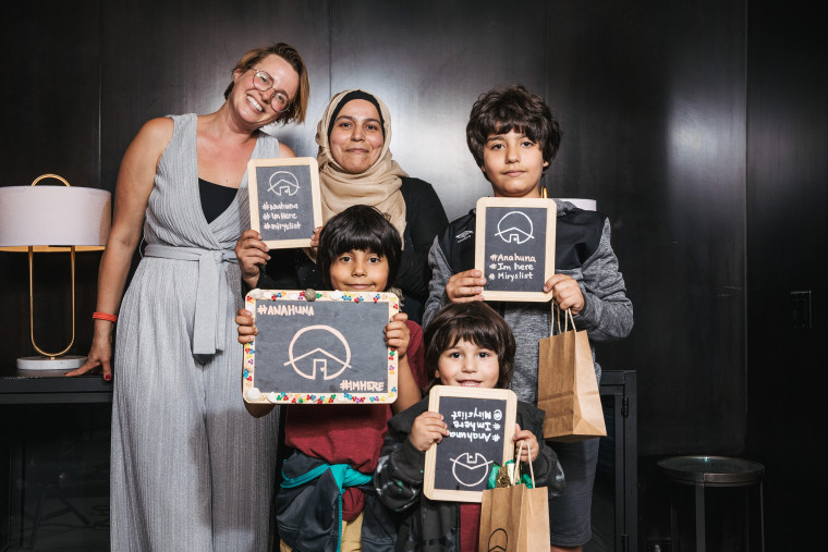 Miry Whitehill (left) at the 2019 World Refugee Day Awards poses with her colleague Huda and her three boys.
