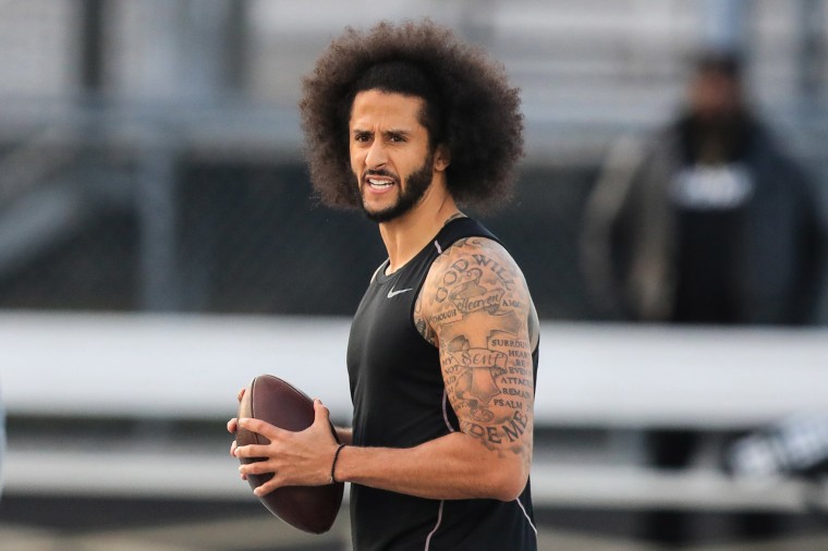 Image: Colin Kaepernick looks to make a pass during a private NFL workout held at Charles R Drew high school