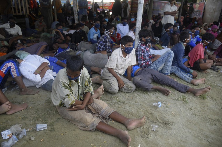 Image: Ethic Rohingya people rest after the boat carrying them landed in Lhokseumawe, Aceh province, Indonesia