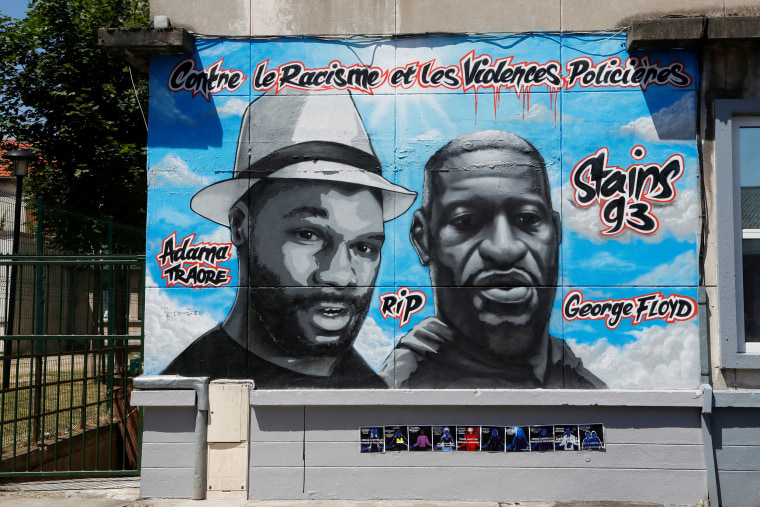 Image: Street art paying tribute to George Floyd and Adama Traore a black man who died in police custody in 2016, on a wall in a street of Stains, in the outskirts of Paris