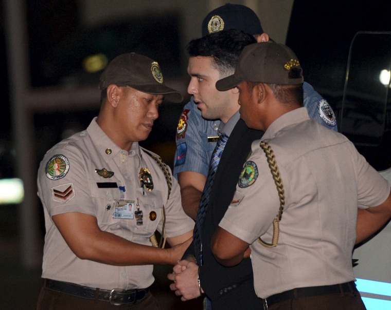 Philippine Bureau of Corrections personnel escort U.S. Marine Lance Corporal Joseph Scott Pemberton at Camp Aguinaldo