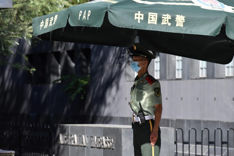 Image: A Chinese paramilitary policeman stands guard outside the Australian embassy in Beijing