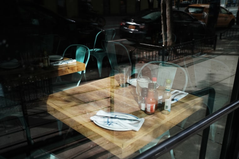 Image: An empty table at a permanently closed restaurant in New York City