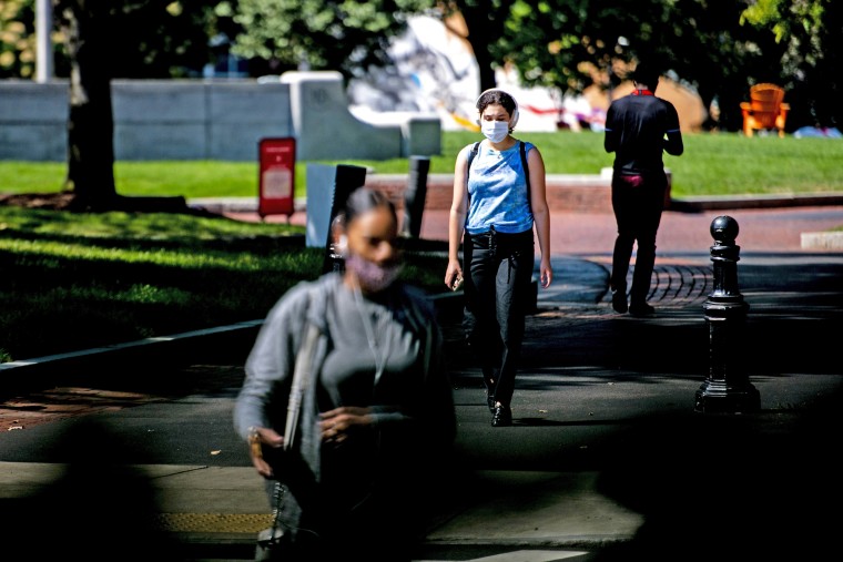 Students walk through Centennial Common at Northeastern University in Boston on Aug. 24, 2020.