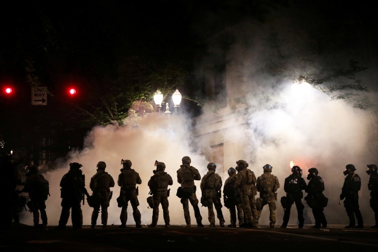 Image: FILE PHOTO: Federal law enforcement officers deployed under the Trump administration's new executive order face off with protesters