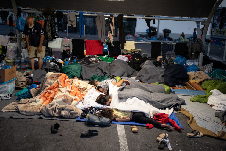 Image: Refugees and migrants from the destroyed Moria camp sleep at the parking space of a supermarket, on the island of Lesbos