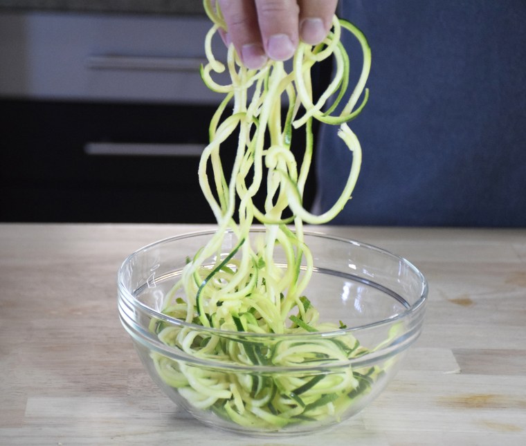 Making Zucchini Noodles with Spiral Slicer on Table Stock Image