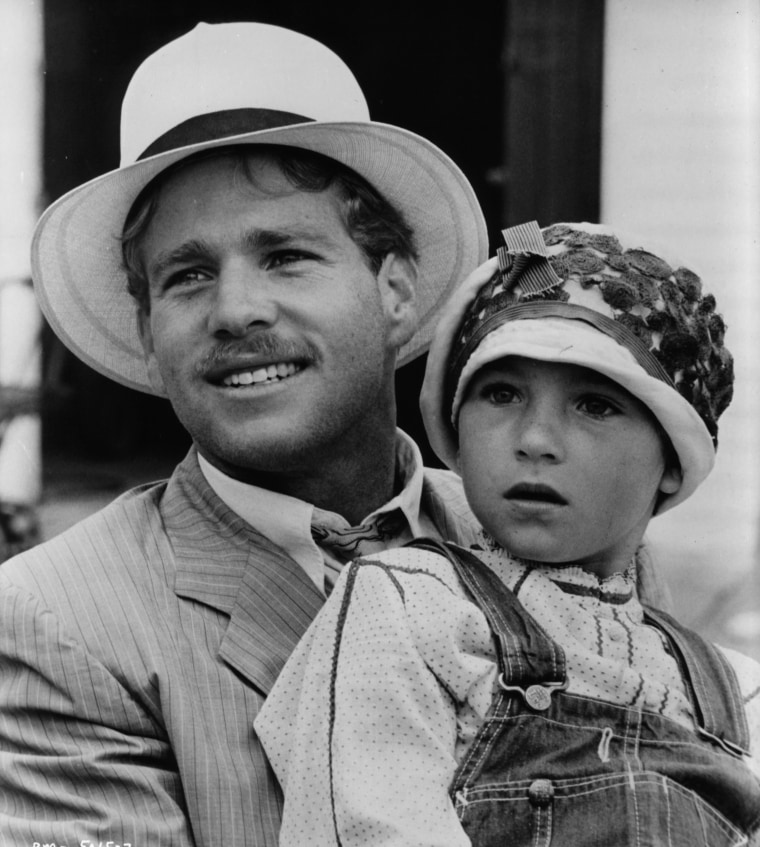 Ryan O'Neal holds Tatum O'Neal in a scene from the film "Paper Moon," in 1973.