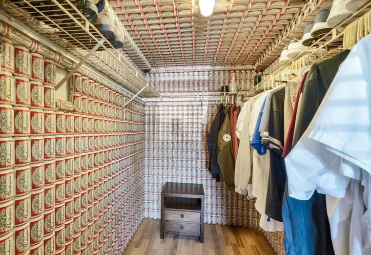 Even the large walk-in closet by the main bedroom is wallpapered in beer cans.