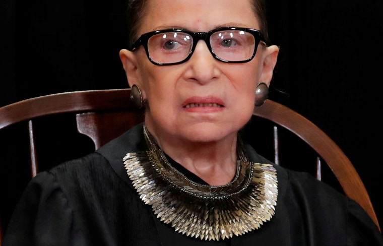U.S. Supreme Court Justice Ruth Bader Ginsburg poses during group portrait at Supreme Court in Washington