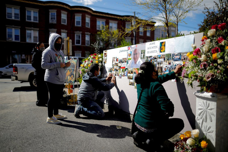 Parishioners prepare a memorial for Jose Agustin Iraheta, who died from Covid-19, before funeral blessings at Saint Rose of Lima Catholic Church in Chelsea, Mass., on May 12.