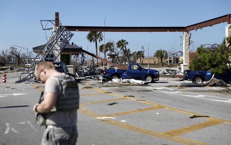 Image: A soldier stands guard at the damaged entrance to Tyndall Air Force Base in Panama City, Forida on Oct. 11, 2018, in the aftermath of hurricane Michael.