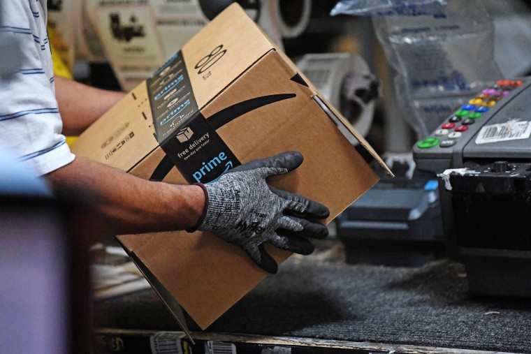 Image: FILE PHOTO: Worker assembles a box for delivery at the Amazon fulfilment center in Baltimore