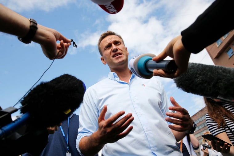 Image: Russian opposition leader Alexei Navalny speaking with journalists during a rally to support opposition and independent candidates