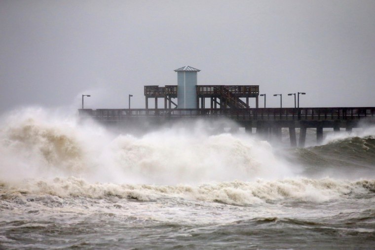 Image: Waves crash along a pier as Hurricane Sally approaches in Gulf Shores