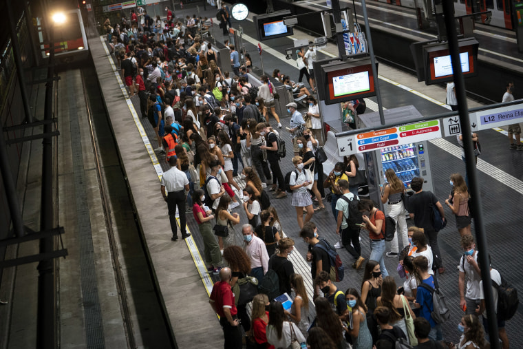 Image: Students wait for the train to go to the university, during a precise moment of rush hour in Barcelona, Spain