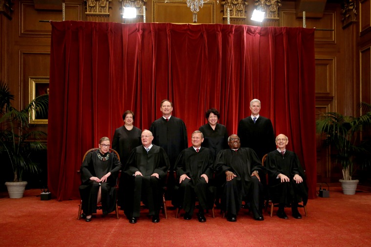 Image: Roberts leads the U.S. Supreme Court in taking a new family photo including Gorsuch, their most recent addition, at the Supreme Court building in Washington