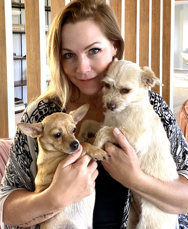 Jennie Garth cuddles two of her dogs.