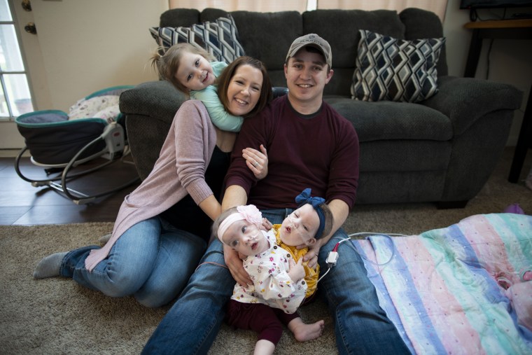 Alyson and Phil Irwin with their daughters, twins, Amelia and Sarabeth, and big sister Kennedy who is almost 4.