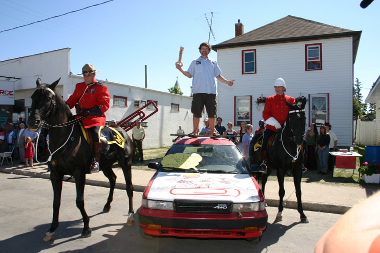 MacDonald stands atop a car during his housewarming party in Kipling, Saskatchewan, in 2006. Hundreds of people attended.