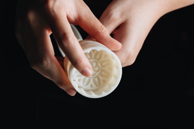 Zhu uses a plastic mooncake press like this one that lends the pastries a floral pattern.