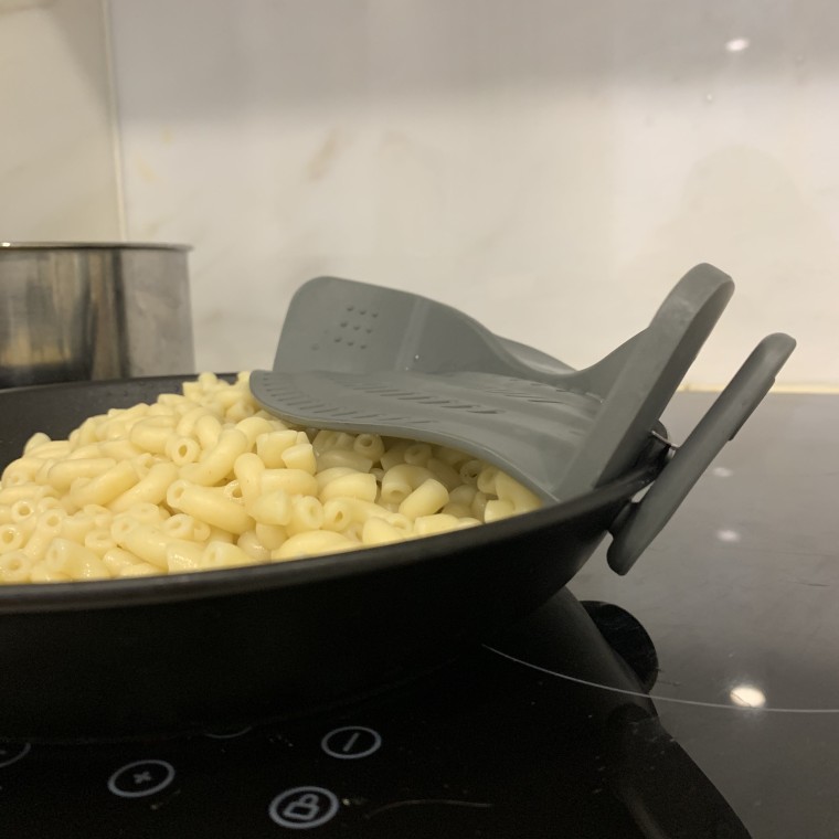 Using the Snap 'n Strain on a cooking pan filled with macaroni