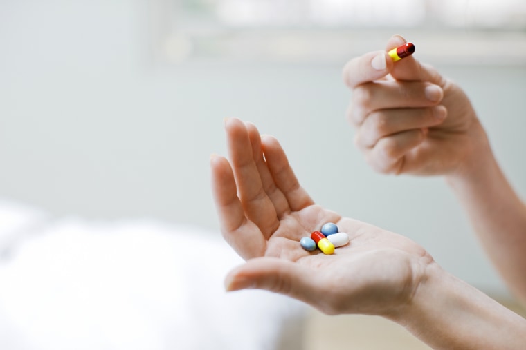 Woman taking vitamins and supplements