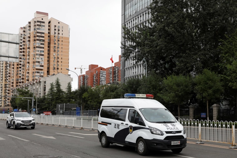 Image: Police van believed to be carrying Ren Zhiqiang