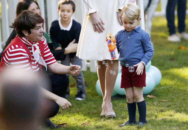 Prince George plays with a bubble gun at a children's party at Government House in Victoria