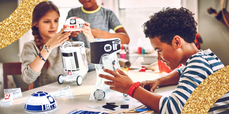 8 year old children playing with star wars droid kit