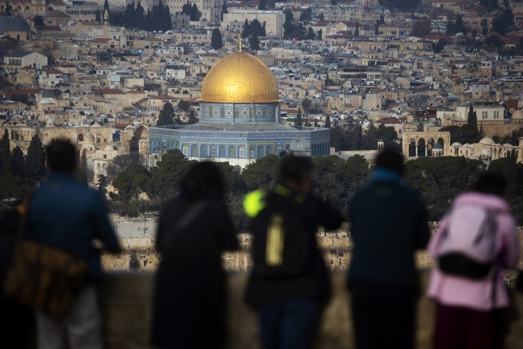 Image: Tourists look out at a view of the Old City of Jerusalem 