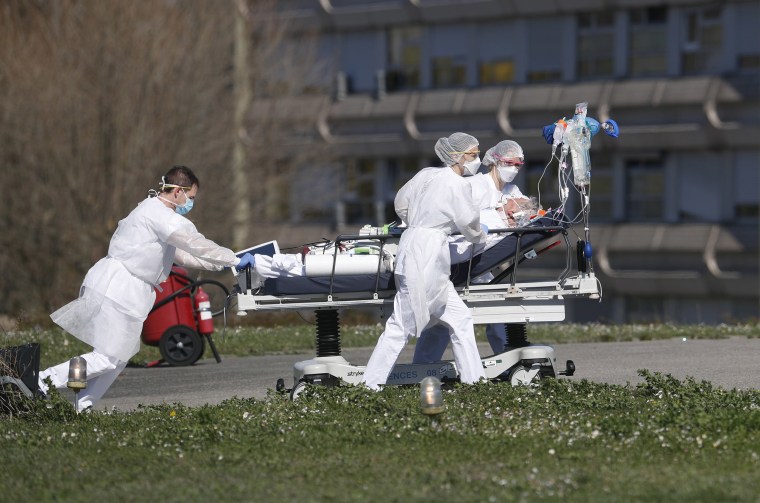 Image: A victim of the Covid-19 virus is evacuated from the Mulhouse civil hospital, eastern France