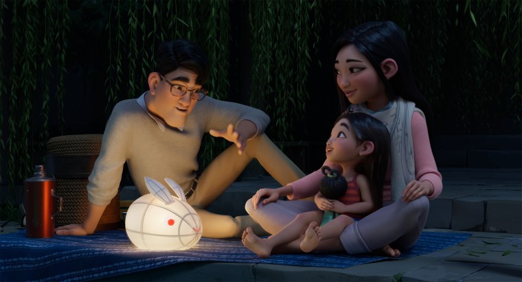 The characters Father, voiced by John Cho, Fei Fei, voiced by Cathy Ang, and Mother, voiced by Ruthie Ann Miles, in a scene from Netflix's "Over the Moon."