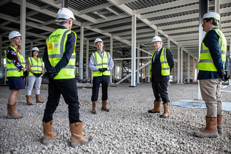 Image: Britain's Prime Minister Boris Johnson talks with scientists as he visits the construction site of the new dedicated Vaccines Manufacturing Innovation Centre near Didcot in central England in September. 